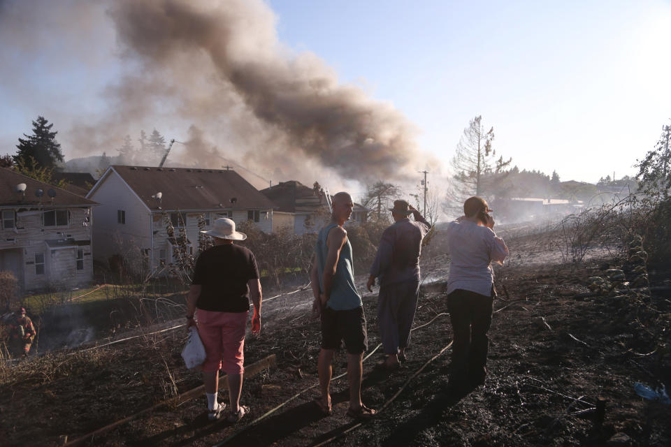 A grass fire seen Monday, Aug. 26, 2019 has burned at least two buildings, prompted evacuations, and shut down multiple roads in Northeast Portland.(Beth Nakamura/The Oregonian via AP)