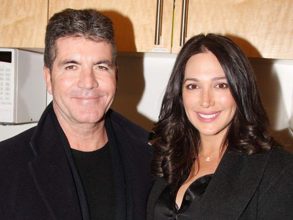 Simon Cowell and partner Lauren Silverman pose backstage at "BEAUTIFUL- The Carole King Musical" on Broadway at The Stephen Sondheim Theater on January 25, 2014 in New York City