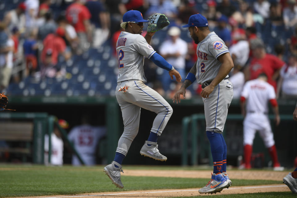 New York Mets shortstop Francisco Lindor (12) and left fielder Dominic Smith (2) celebrate after the first baseball game of a doubleheader against the Washington Nationals, Saturday, June 19, 2021, in Washington. The Mets won 5-1. (AP Photo/Nick Wass)