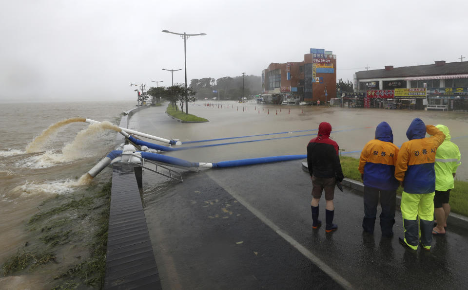 Officials from Gangneung city pump out water from a flooded area due to heavy rain in Gangneung, South Korea, Monday, Sept. 7, 2020. A powerful typhoon damaged buildings, flooded roads and knocked out power to thousands of homes in South Korea on Monday after battering islands in southern Japan and injuring dozens of people. (Yang Ji-woong/Yonhap via AP)