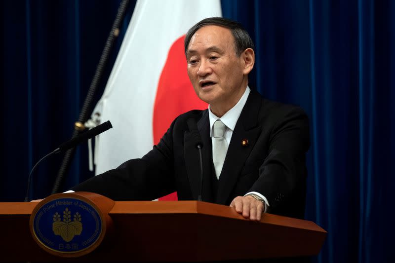 FILE PHOTO: FILE PHOTO: Yoshihide Suga speaks during a news conference following his confirmation as Prime Minister of Japan in Tokyo