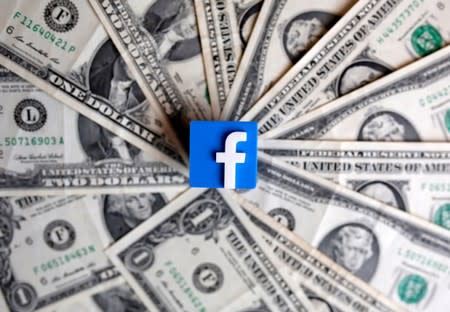 FILE PHOTO: A 3-D printed Facebook logo is seen on U.S. dollar banknotes in this illustration picture