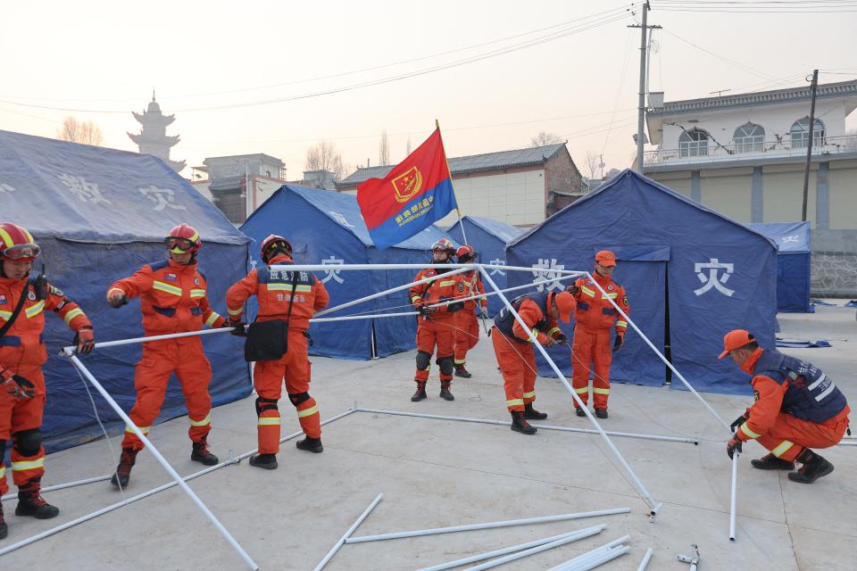 Rescue workers set up tents for people evacuated after an earthquake in Dahejia, Jishishan County, in northwest China's Gansu province (AFP via Getty Images)