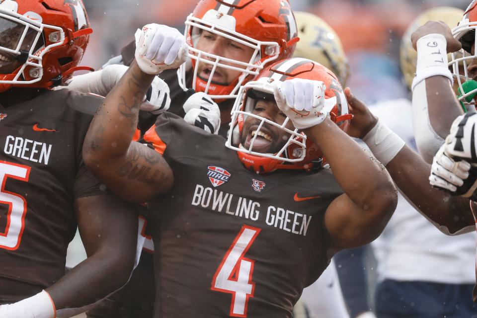 Bowling Green running back Terion Stewart (4) celebrates a touchdown in the first half against Akron on Saturday in Bowling Green.