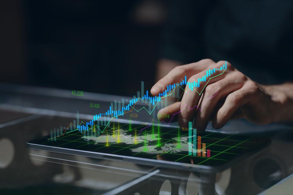 A hand hovers above a digital image of a chart.