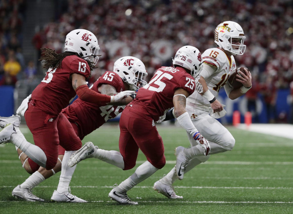 Iowa State quarterback Brock Purdy (15) is stopped short of a first down by Washington State defenders Skyler Thomas (25) and Logan Tago (45) during the second half of the Alamo Bowl NCAA college football game Friday, Dec. 28, 2018, in San Antonio. (AP Photo/Eric Gay)