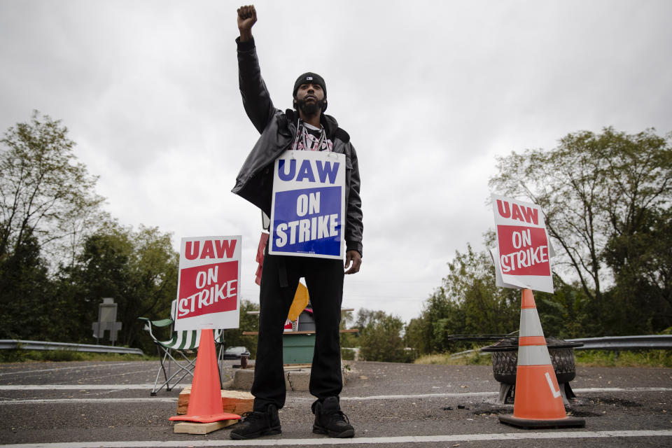 Ryan Piper with the United Auto Workers continues to picket after news of a tentative contract agreement with General Motors, in Langhorne, Pa., Wednesday, Oct. 16, 2019. Bargainers for General Motors and the United Auto Workers reached a tentative contract deal on Wednesday that could end a monthlong strike that brought the company's U.S. factories to a standstill. (AP Photo/Matt Rourke)