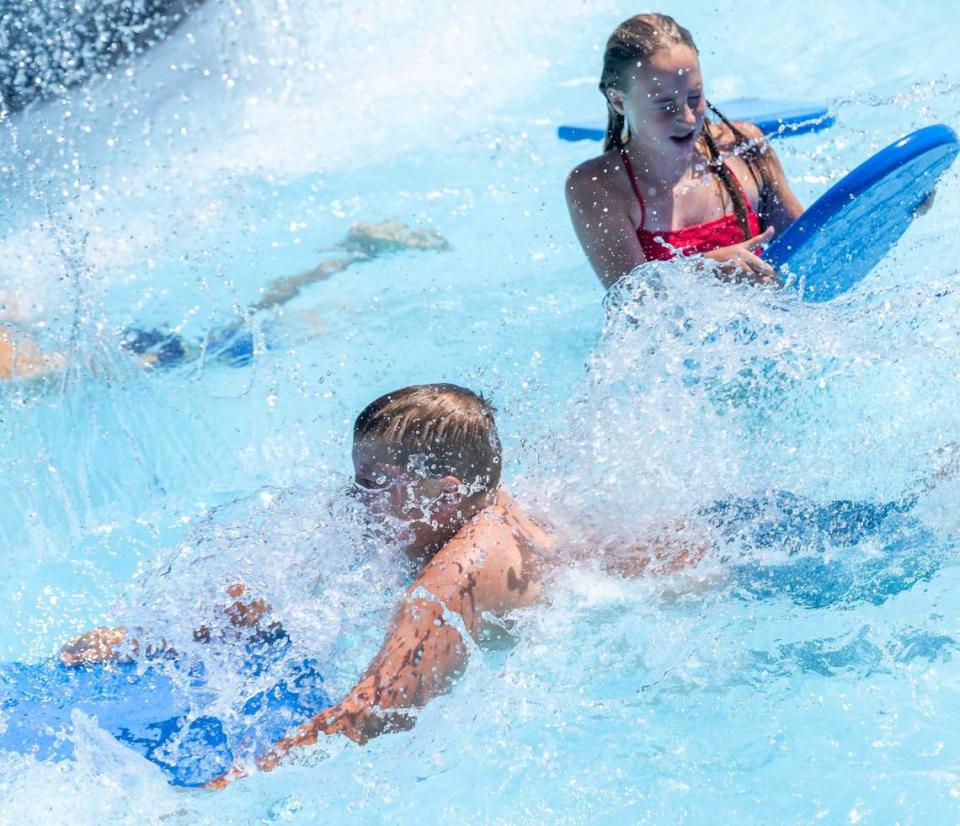 Children splash in the water on the action river.