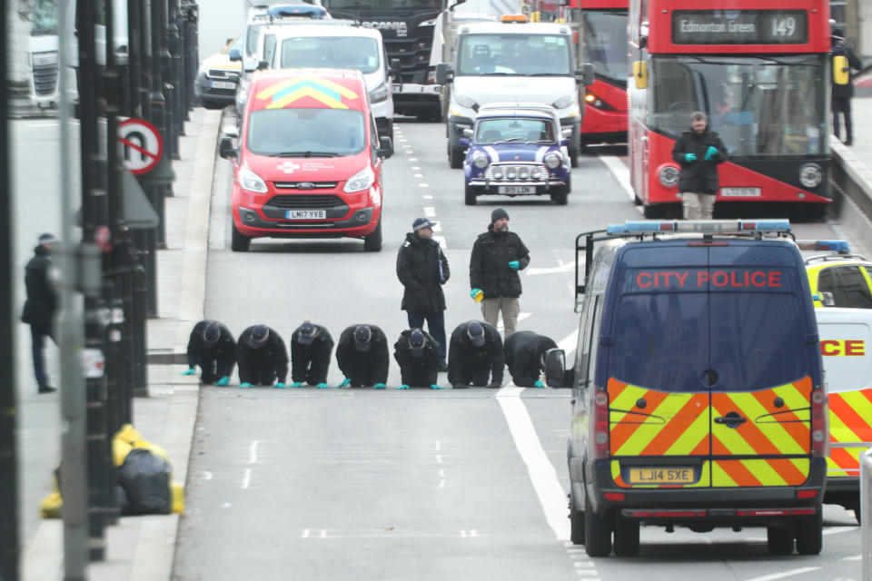 Forensic personnel searching for fingerprints at the cordoned off area on London Bridge in central London, after a terrorist wearing a fake suicide vest who went on a knife rampage killing two people, was shot dead by police on Friday. (Photo by Yui Mok/PA Images via Getty Images)