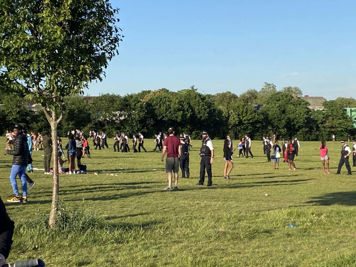 Police officers breaking up a large brawl on Hampstead Heath in north London on Tuesday evening: PA