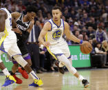 Sacramento Kings guard De'Aaron Fox, left, tries to fight through a screen as he guards against Golden State Warriors guard Stephen Curry, right, during the first half of an NBA basketball game Friday, Dec. 14, 2018, in Sacramento, Calif. (AP Photo/Rich Pedroncelli)