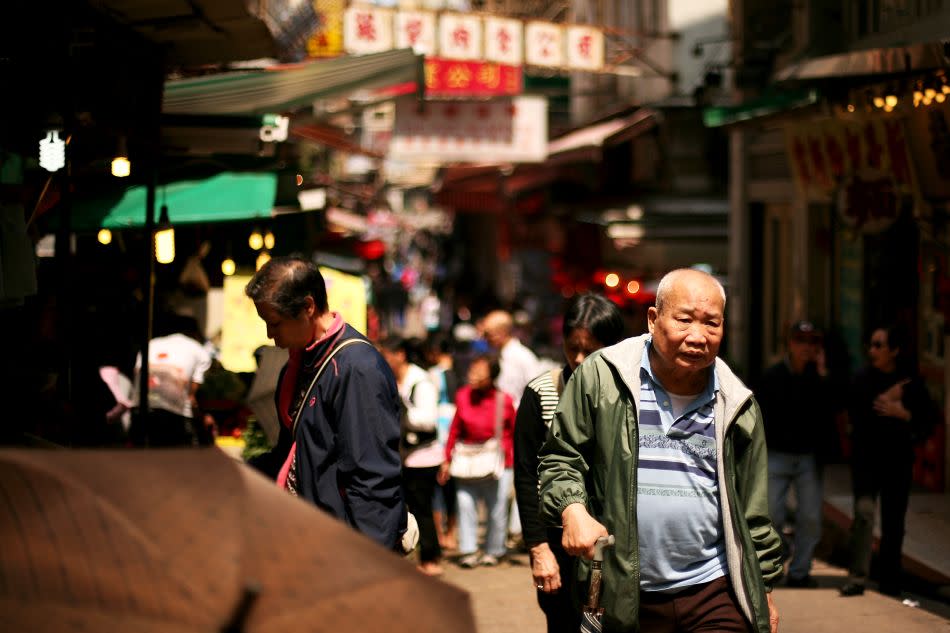 Shoppers walk in a Hong Kong street.
