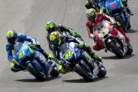 Yamaha MotoGP rider Valentino Rossi of Italy (C) leads the pack at the start of the race at the TT Assen Grand Prix at Assen, Netherlands June 27, 2015. REUTERS/Ronald Fleurbaaij