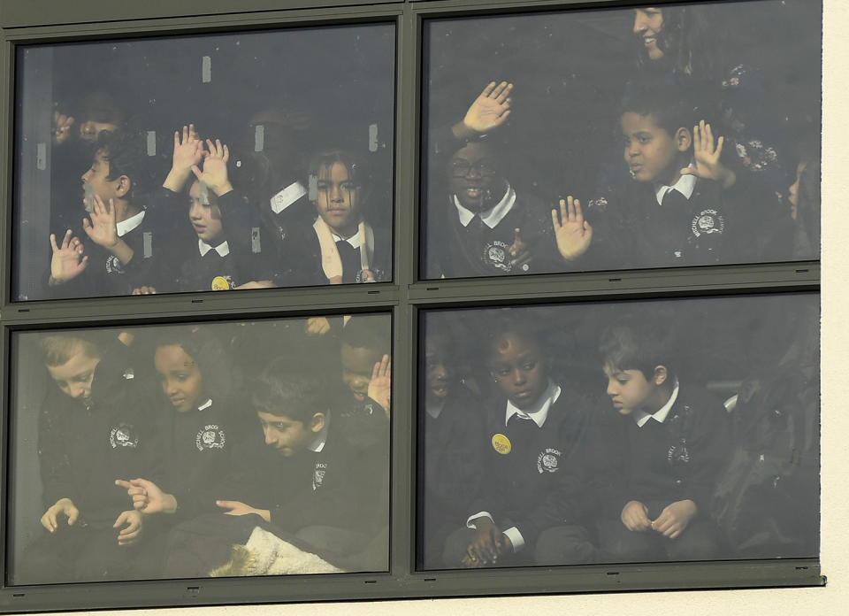 School pupils watch as Britain’s Catherine the Duchess of Cambridge and Prince William