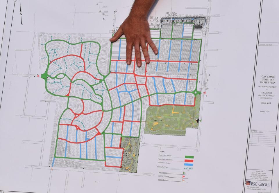 Casey-Lee Bastien, landscape architect with BSC Group, displays a map of Oak Grove Cemetery with roads colored in green, red and blue on Wednesday, May 24. The green roads are considered primary roads, the red ones secondary roads, and the blue ones tertiary roads.