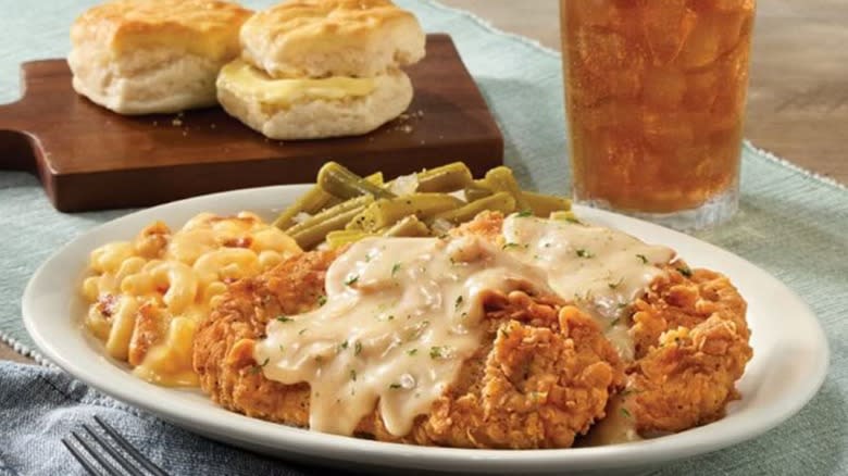 fried pork chops and gravy, macaroni and cheese, green beans, biscuits, and iced tea