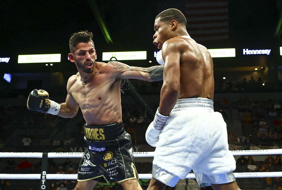 Jorge Linares, left, hits Devin Haney during a WBC lightweight title boxing match Saturday, May 29, 2021, in Las Vegas. (AP Photo/Chase Stevens)