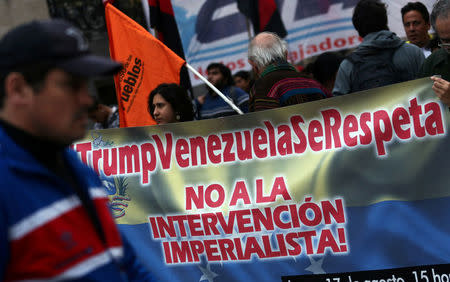 A man walks past a banner during a demonstration in support of Venezuela's government and against the threats made by U.S. President Donald Trump of a possible armed intervention outside Argentina's Foreign Ministry in Buenos Aires, Argentina August 17, 2017. REUTERS/Marcos Brindicci