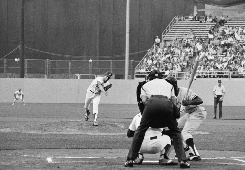 File-This Oct. 17, 1978, file photo shows, Los Angeles Dodgers pitcher Don Sutton, left, following through as he fires his first pitch in World Series Game in Los Angeles. Sutton, a Hall of Fame pitcher who was a stalwart of the Los Angeles Dodgers' rotation spanning an era from Sandy Koufax to Fernando Valenzuela, died Tuesday, Jan. 19, 2021. He was 75. The Baseball Hall of Fame in Cooperstown, New York, said Sutton died at his home in Rancho Mirage, California, after a long struggle with cancer. The Atlanta Braves, where Sutton was a long-time broadcaster, said he died in his sleep. (AP Photo, File)