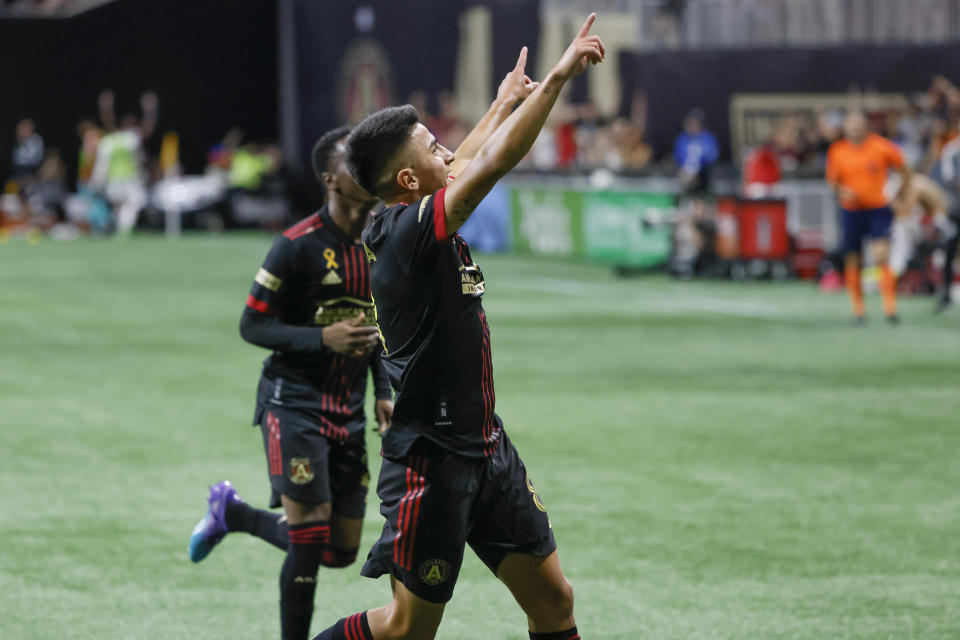 Atlanta United's Ezequiel Barco, foreground, celebrates his second-half goal during an MLS soccer match against the Toronto FC, Saturday, Sept. 10, 2022, in Atlanta. (AP Photo/Bob Andres)
