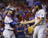 Los Angeles Dodgers catcher Yasmani Grandal, left, and relief pitcher Kenley Jansen celebrate after the last out in the ninth inning of a baseball game against the St. Louis Cardinals Thursday, Sept. 13, 2018, in St. Louis. (AP Photo/Billy Hurst)