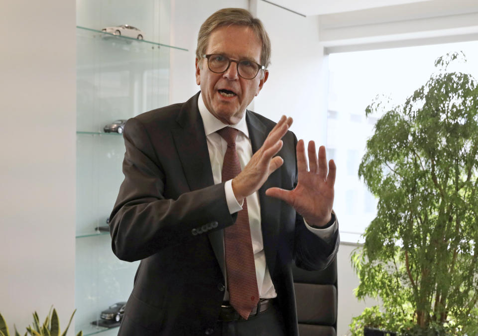 In this Friday, Oct. 12, 2018, photo, Volkswagen Group China chief executive Jochem Heizmann reacts during an interview in Beijing. More than 200 manufacturers, including Tesla, Volkswagen, BMW, Daimler, Ford, General Motors, Nissan, Mitsubishi and U.S.-listed electric vehicle start-up NIO, transmit position information and dozens of other data points to Chinese government-backed monitoring centers, The Associated Press has found. Generally, it happens without car owners' knowledge. (AP Photo/Ng Han Guan)