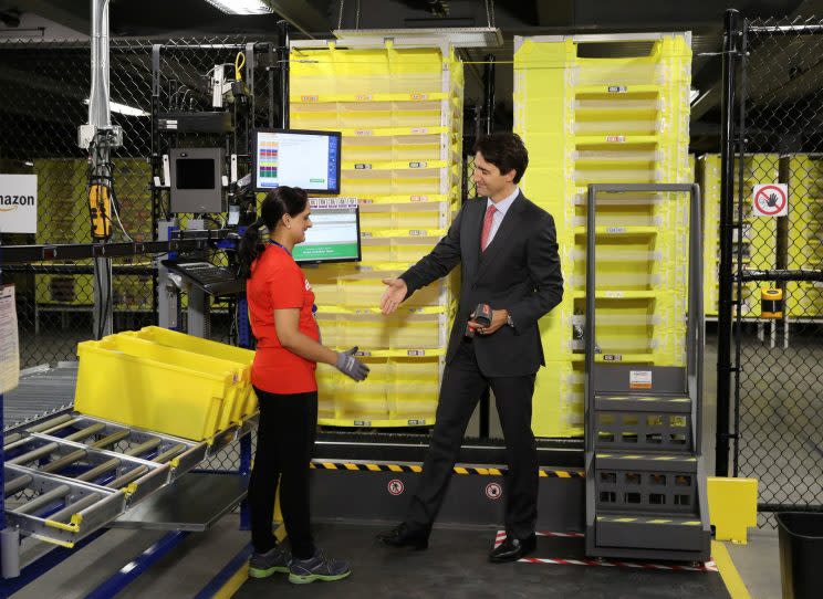 Canada's Prime Minister Justin Trudeau scans merchandise with an employee during a tour of the Amazon Fulfillment Centre in Brampton, Ontario, Canada October 20, 2016. REUTERS/Fred Thornhill