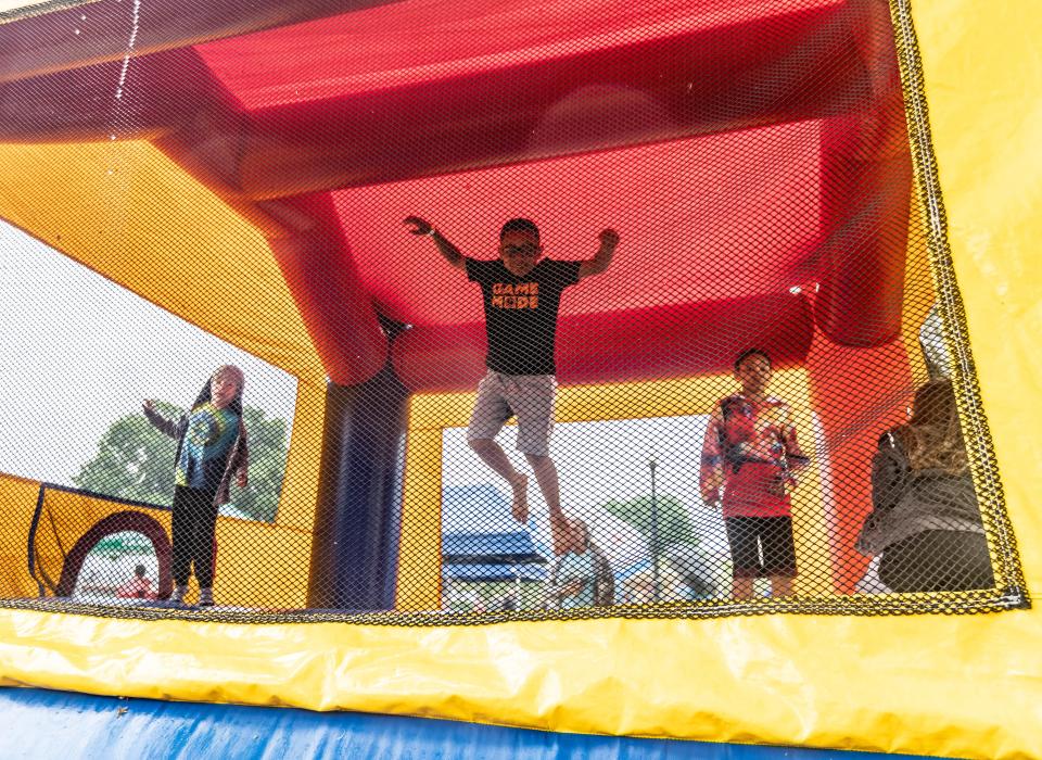 Children jumping inside a bounce house.