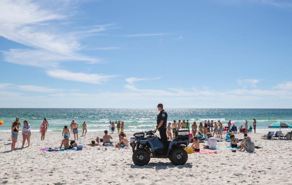 Panama City Police patrol the beach in front of the SpringHill Suites. The sands along Panama City Beach were crowded with Spring Breakers enjoying warm weather Thursday, March 17, 2022.