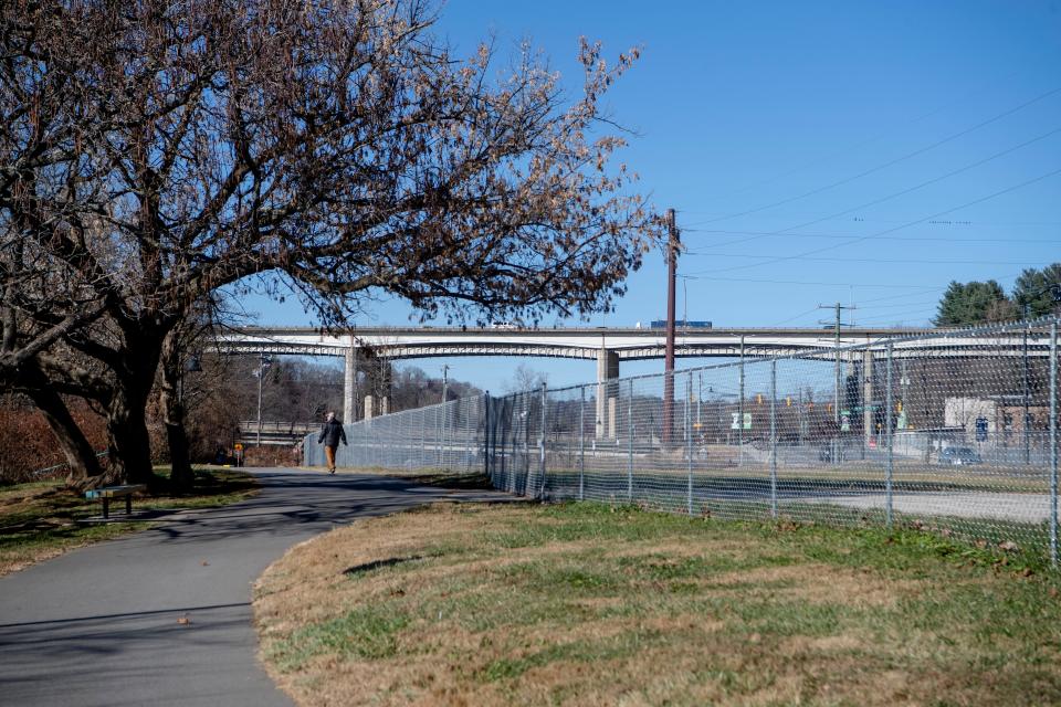 A fence around a parcel of land at 144 Riverside Drive, between the road and Wilma Dykeman Greenway, in the River Arts District.