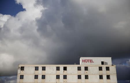 Demolition work takes place on the Howard Park Hotel in Kilmarnock, Scotland March 25, 2014. The Scottish capital, Edinburgh, has an air of prosperity that explains why so many of its residents are happy with their lot and unwilling to risk the changes independence may bring. But in Kilmarnock it is a different story. REUTERS/Suzanne Plunkett