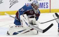 Colorado Avalanche goaltender Philipp Grubauer stops the puck on a shot by the San Jose Sharks during the second period of an NHL hockey game Tuesday, Jan. 26, 2021, in Denver. (AP Photo/David Zalubowski)