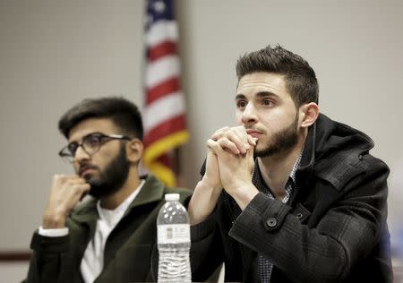 University of California Los Angeles student Abdullah Haikal (R), 22, and University of California Irvine student Maaz Munir ,19, watch the Republican presidential debate at the Council on American-Islamic Relations (CAIR) office in Anaheim, California December 15, 2015. REUTERS/Jason Redmond