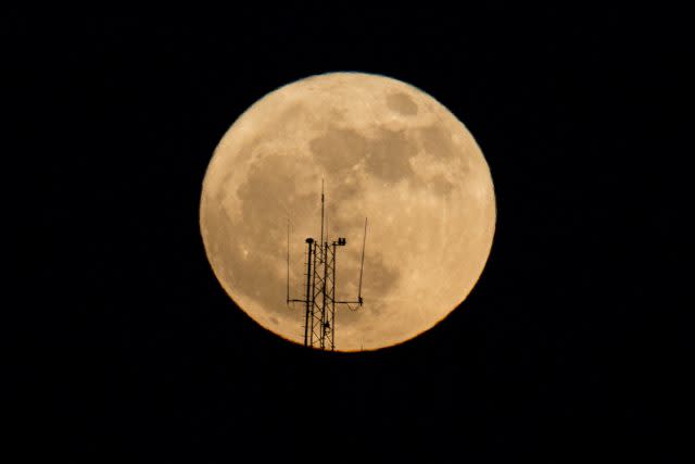 The moon rises over a building in Netanya, Israel (Ariel Schalit/AP)