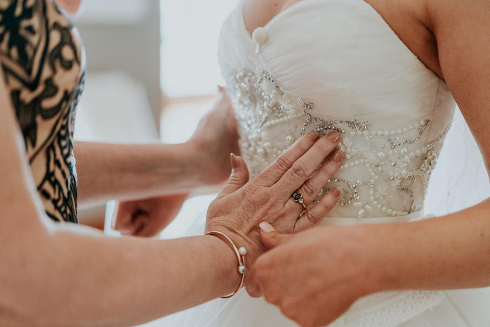 In this close-up shot, Agnew's mother uses her hands to feel the beading on the bodice of her daughter's wedding gown. (Photo: <a href="https://www.jamesday.com.au/" target="_blank">James Day Photography</a>)