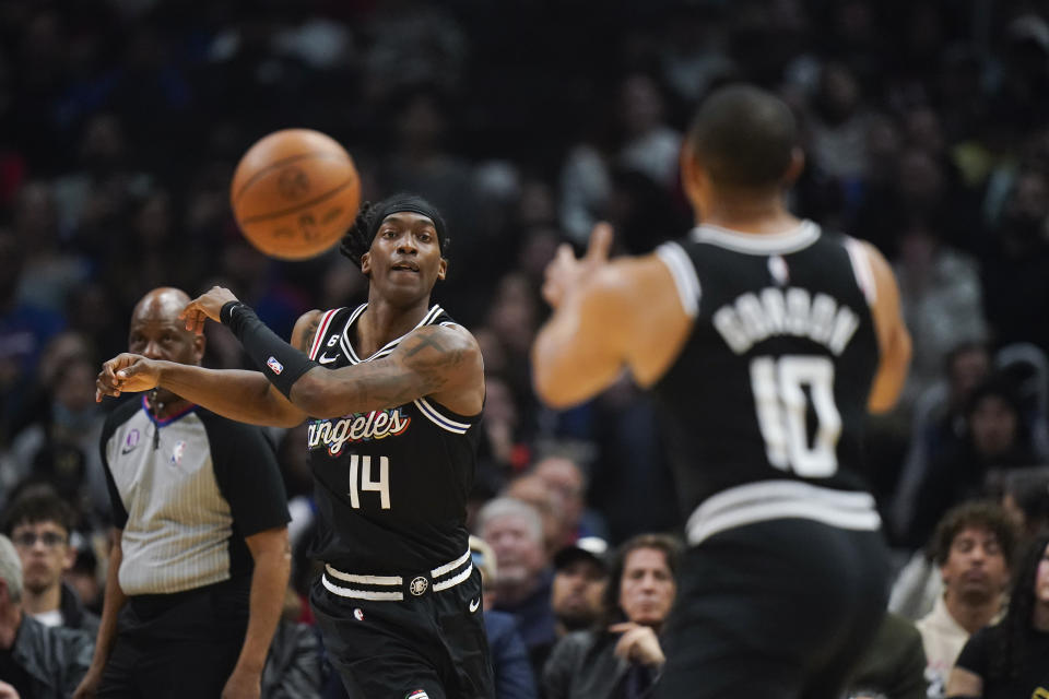 Los Angeles Clippers' Terance Mann (14) passes to Eric Gordon (10) during first half of an NBA basketball game against the Toronto Raptors Wednesday, March 8, 2023, in Los Angeles. (AP Photo/Jae C. Hong)