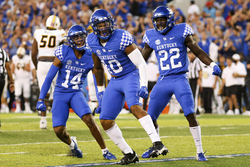 Kentucky defensive back Carrington Valentine (14), linebacker Jacquez Jones (10) and defensive back Yusuf Corker (22) celebrate stopping Missouri on third down during the first half of an NCAA college football game against Missouri in Lexington, Ky., Saturday, Sept. 11, 2021. (AP Photo/Michael Clubb)