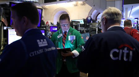 FILE PHOTO: Traders work on the floor at the New York Stock Exchange (NYSE) in New York, U.S., May 14, 2019. REUTERS/Brendan McDermid/File Photo