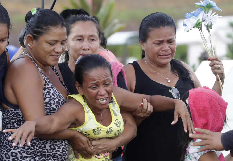 Antonia Alves grieves as she is held by relatives during the burial of her son Jairo Alves Figueiredo, an inmate who was killed in the recent prison riots, at a cemetery in Manaus, Brazil, Thursday, May 30, 2019. Families were burying victims of several prison riots in which dozens of inmates died in the northern Brazilian state of Amazonas, as authorities confirmed they had received warnings of an “imminent confrontation” days before the attacks begun. (AP Photo/Andre Penner)