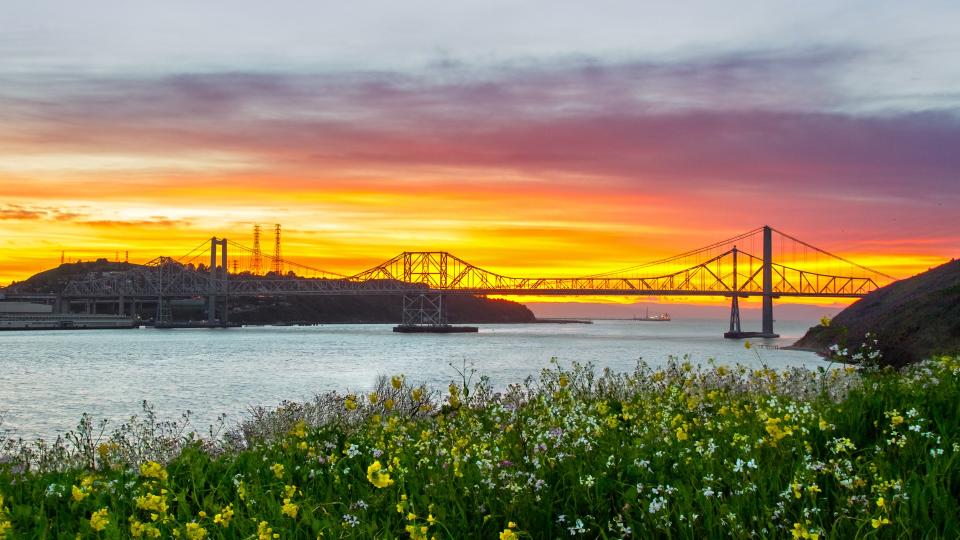 Sunset lights up the sky behind the Carquinez bridge in the Bay area of California.