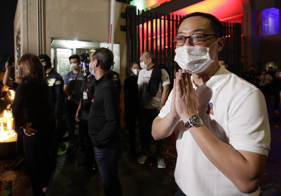 ABS-CBN President and CEO Carlo Katigbak, right, gestures to supporters and employees outside their headquarters in Quezon City, Philippines Friday July 10, 2020. Philippine lawmakers voted Friday to reject the license renewal of the country's largest TV network ABS-CBN, shutting down a major news provider that had been repeatedly threatened by the president over its critical coverage. (AP Photo/Aaron Favila)