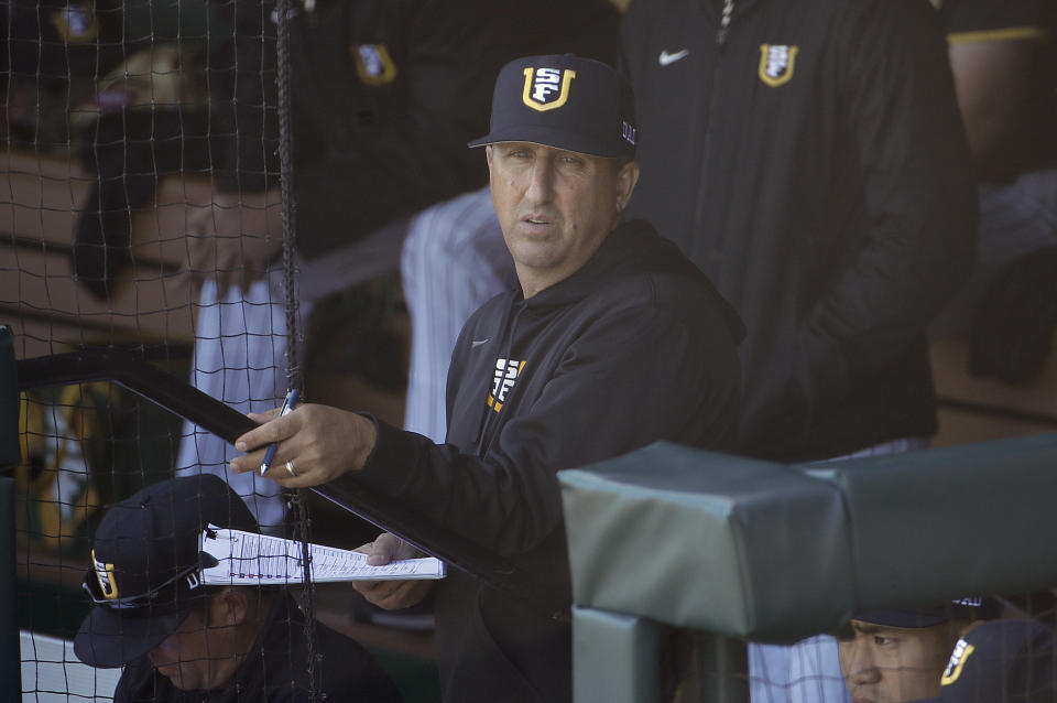 FILE - In this April 9, 2019, file photo, San Francisco head coach Nino Giarratano watches action against Stanford during an NCAA college baseball game in San Francisco. As thousands of college athletes and coaches across the country try to adjust after the sudden suspensions of entire seasons of competition and perhaps more so the camaraderie of daily practices, training sessions and team meals, communication specialists and mental health professionals are encouraging those involved to allow these young men and women to go through the stages of grieving as needed. "It is very similar to grieving," said Giarratano. "We are in contact daily trying to help them academically, athletically and keeping their spirits up." (AP Photo/Jeff Chiu, File)