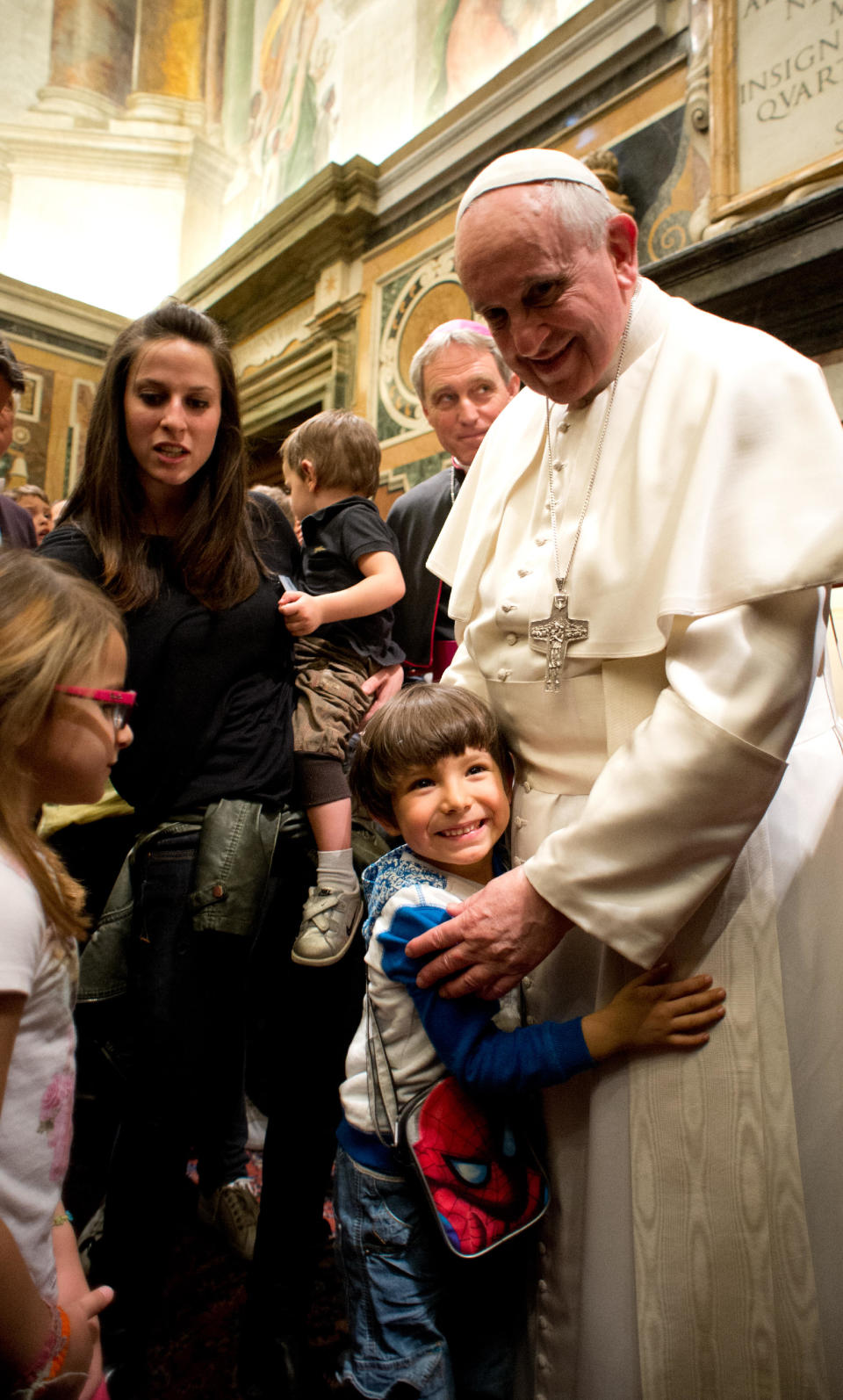 In this photo released by Vatican newspaper L'Osservatore Romano, Pope Francis hugs a child during a meeting with the Italian pro-life movement, at the Vatican Friday, April 11, 2014. (AP Photo/L'Osservatore Romano)