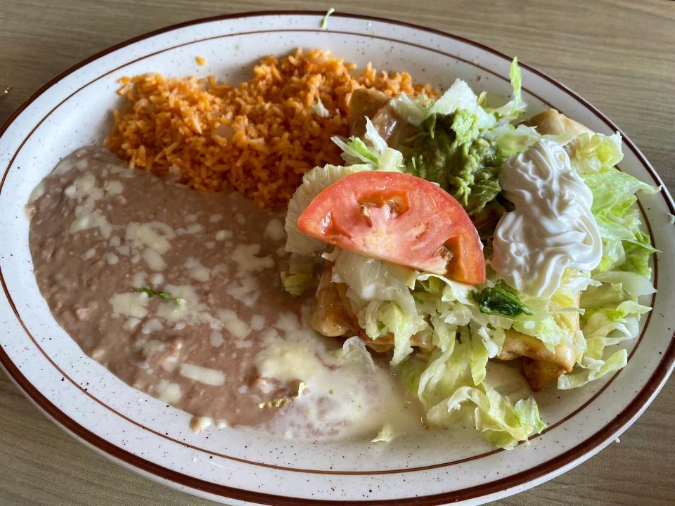 Chimichangas come with two chimichangas — one beef, one chicken — topped with lettuce, tomatoes, sour cream, cheese dip and guacamole. They’re served with a side of refried beans and rice.
