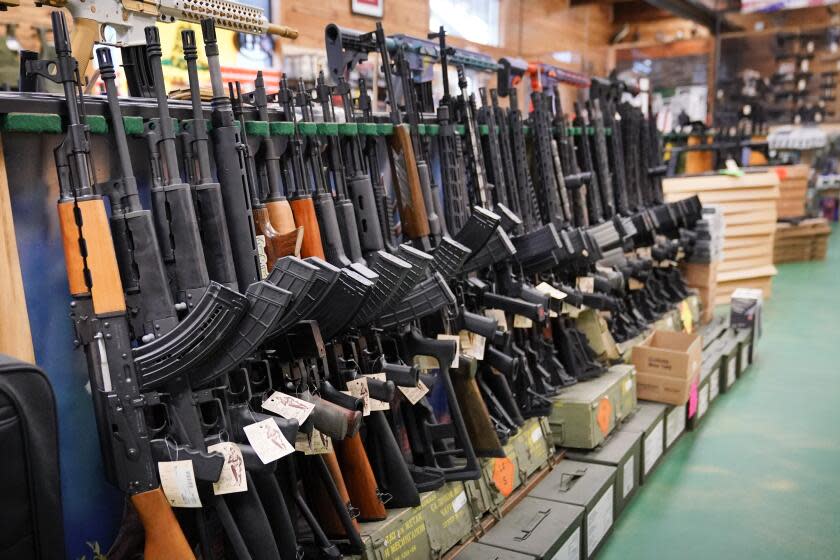 FILE - Assault rifles are displayed at Coastal Trading and Pawn, Monday, July 18, 2022, in Auburn, Maine. President Joe Biden and the Democrats have become increasingly emboldened in pushing for stronger gun control. The Democratic-led House passed legislation in July to revive a 1990s-era ban on assault weapons, with Biden's vocal support. And the president pushed the weapons ban nearly everywhere that he campaigned this year. (AP Photo/Robert F. Bukaty, File)