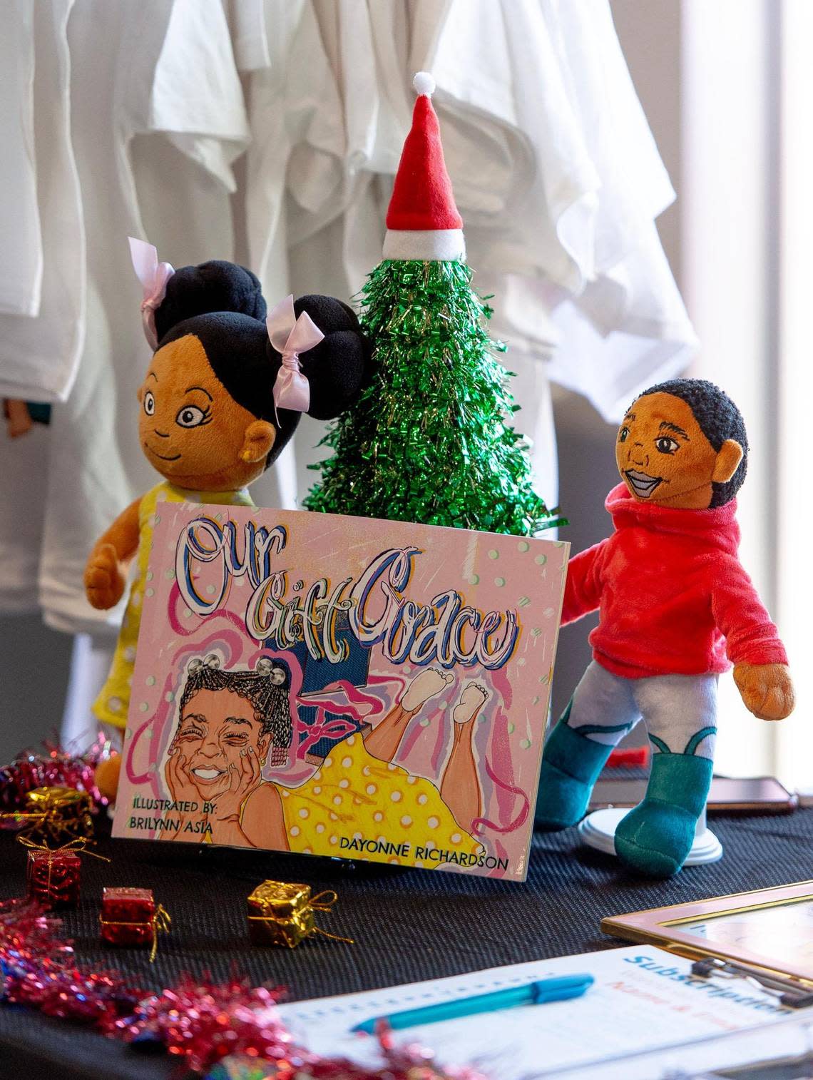 Stuffed dolls portraying Grace and Emery, two characters of author Dayonne Richardson’s children’s books, are on display at a Black vendor fair.