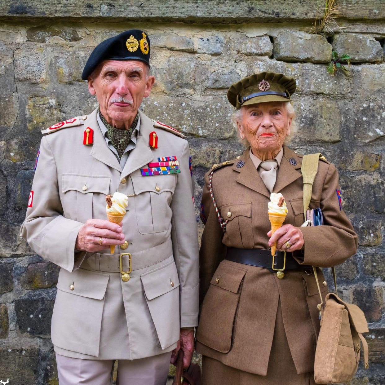 An elderly couple in WWII uniforms enjoying an ice cream at the National Tramways Museum in Derbyshire. - Rick Corbishley./This Is Britain