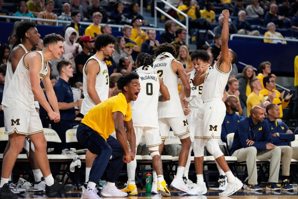 Michigan guard Jace Howard, yellow shirt, and team react after a teammate's three-point basket during the second half at Crisler Center in Ann Arbor on Friday, Nov. 3, 2023.