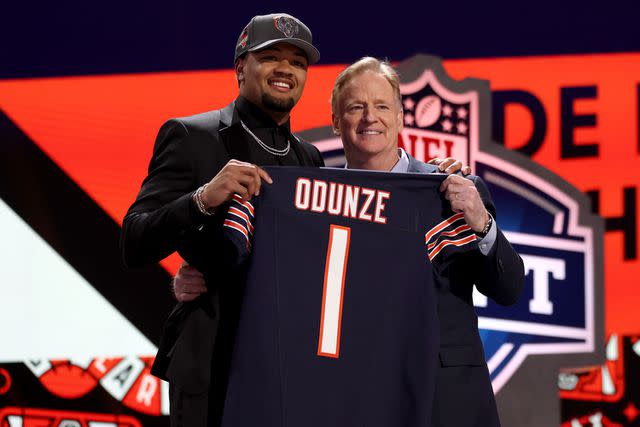 <p>Gregory Shamus/Getty</p> Rome Odunze poses with NFL Commissioner Roger Goodell after being selected by the Chicago Bears in the 2024 NFL Draft.