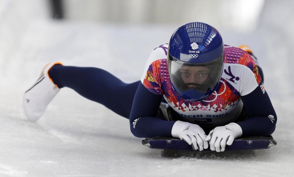 Elizabeth Yarnold of Great Britain brakes in the finish area after her first run during the women's skeleton competition at the 2014 Winter Olympics, Thursday, Feb. 13, 2014, in Krasnaya Polyana, Russia. (AP Photo/Natacha Pisarenko)